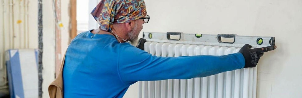 A man fitting a column radiator