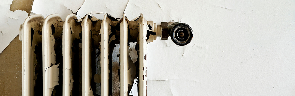 An old cast iron radiator with paint peeling