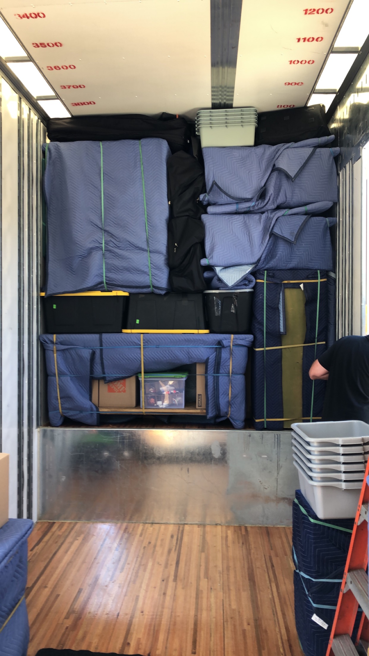 Triple R Moving team member carrying furniture during a Central Oregon move