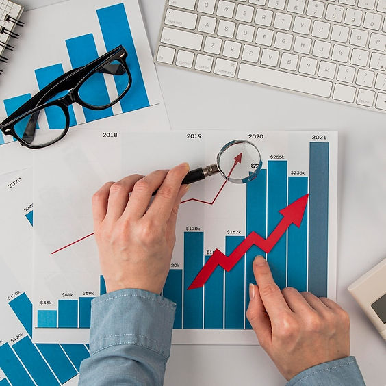 top-view-office-desk-with-growth-chart-hands-holding-magnifying-glass_23-2148780614.jpg
