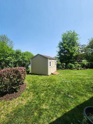 Light yellow shed with double doors