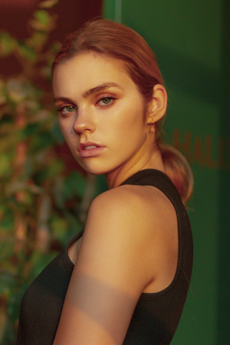 Portrait of a young woman looking over her shoulder