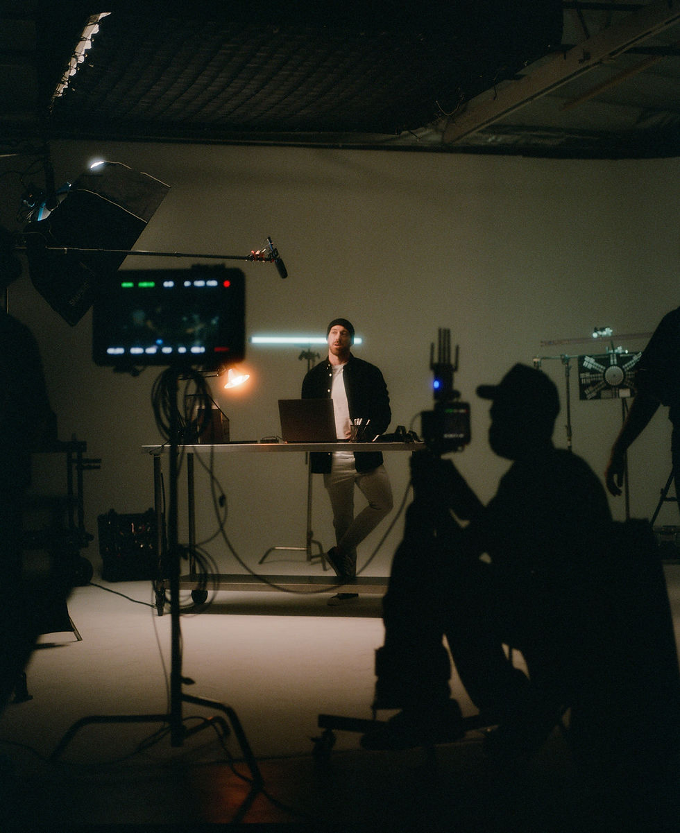 Man filmed in studio with lights and camera