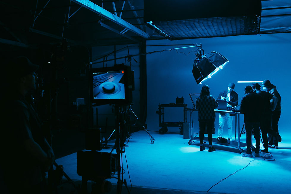 Camera and crew in a blue-lit film studio