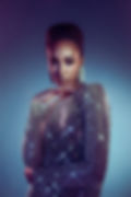 Confident woman in shimmering top against blue background