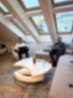 Two men working in a modern office with skylights