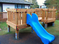 Low level commercial play tower with slide