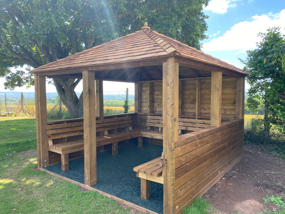 Shelter with seating and resin bonded rubber flooring