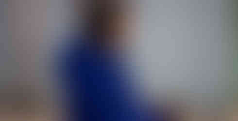 A woman in a blue ski jacket looking off camera