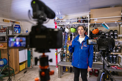 Woman being interviewed on camera in a ski shop