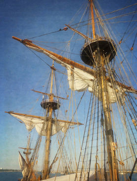 Nautical coastal wall art of the masts of a tall ship on a blue sky day.