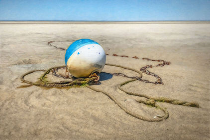 Photographic coastal still life wall art of an aqua blue and white buoy on the beach.