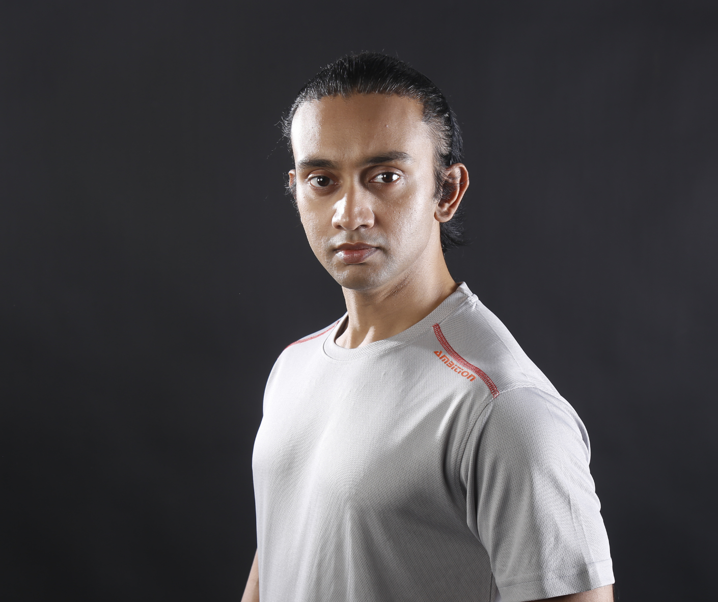 Man in grey shirt, serious expression
