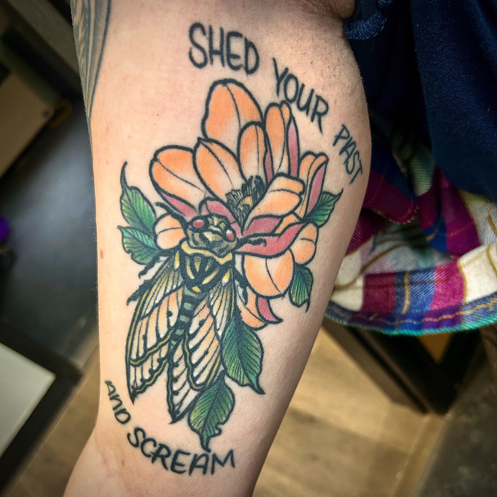 a tattoo on a person 's arm that says shed your past and scream