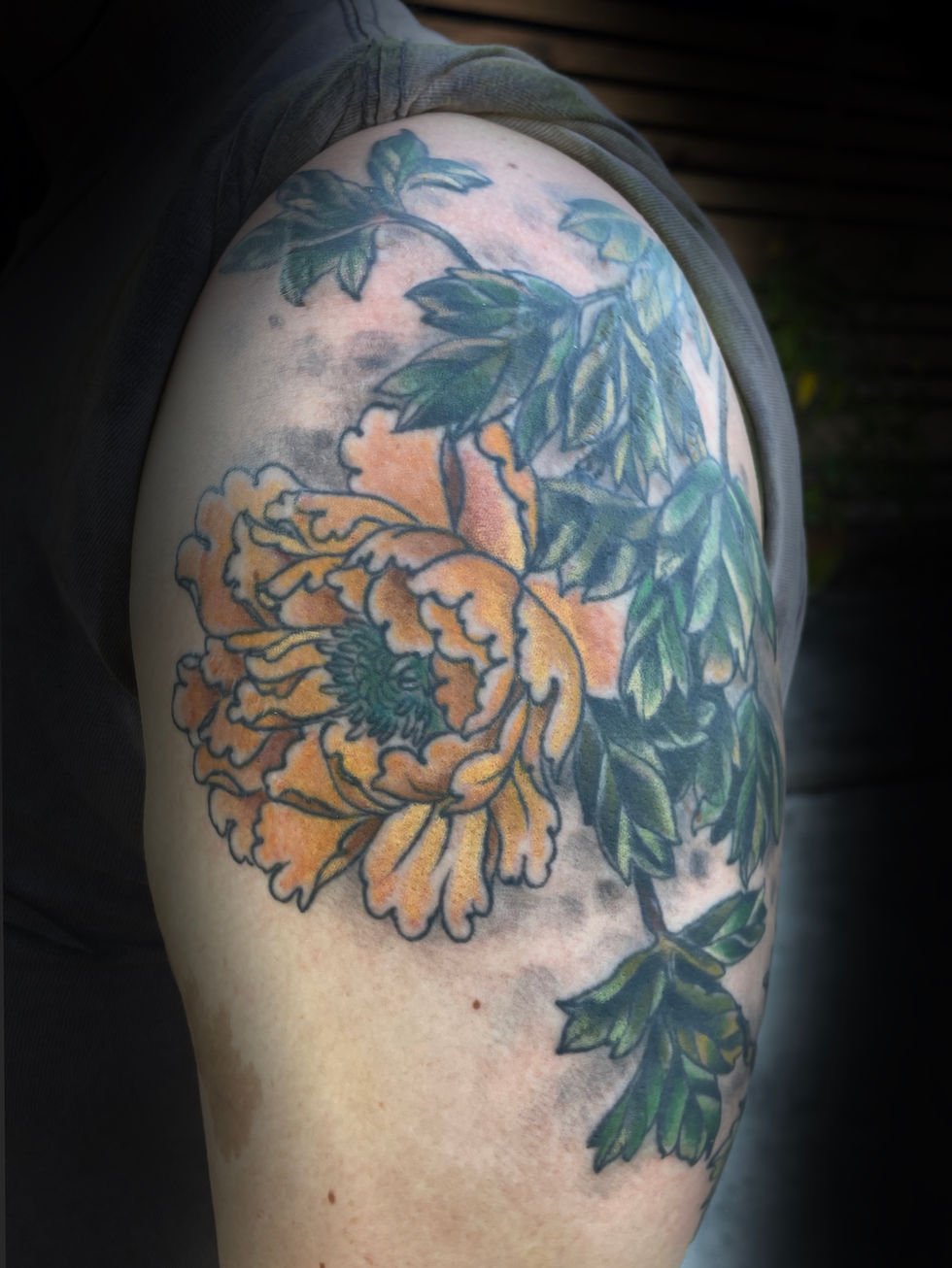 a person has a tattoo of a flower on their arm