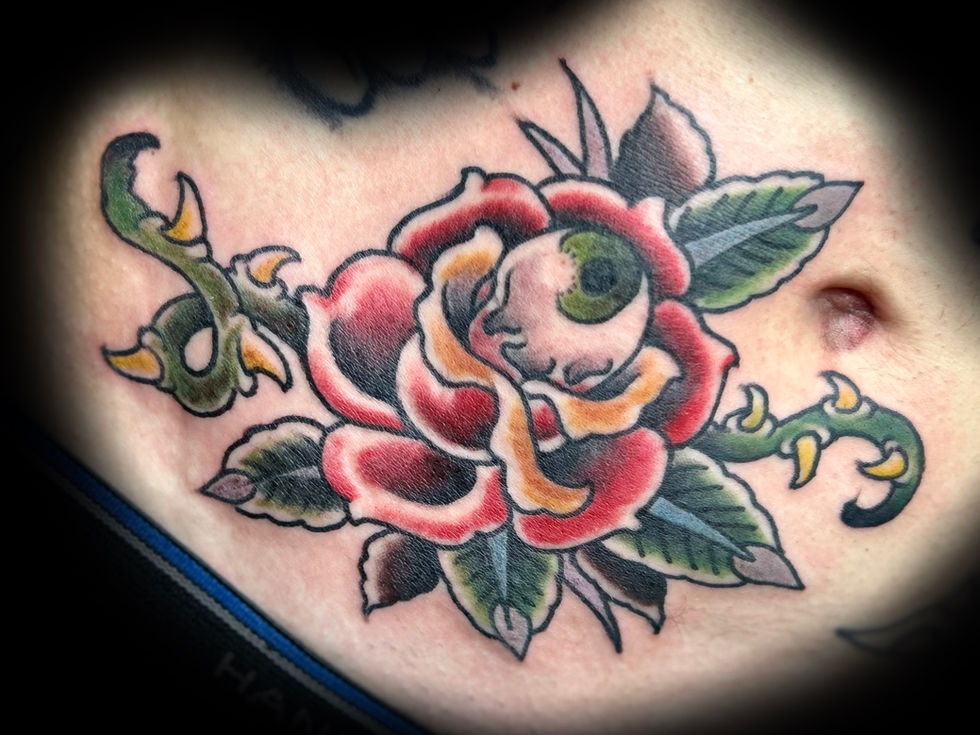 a close up of a tattoo of a rose with an eye on it