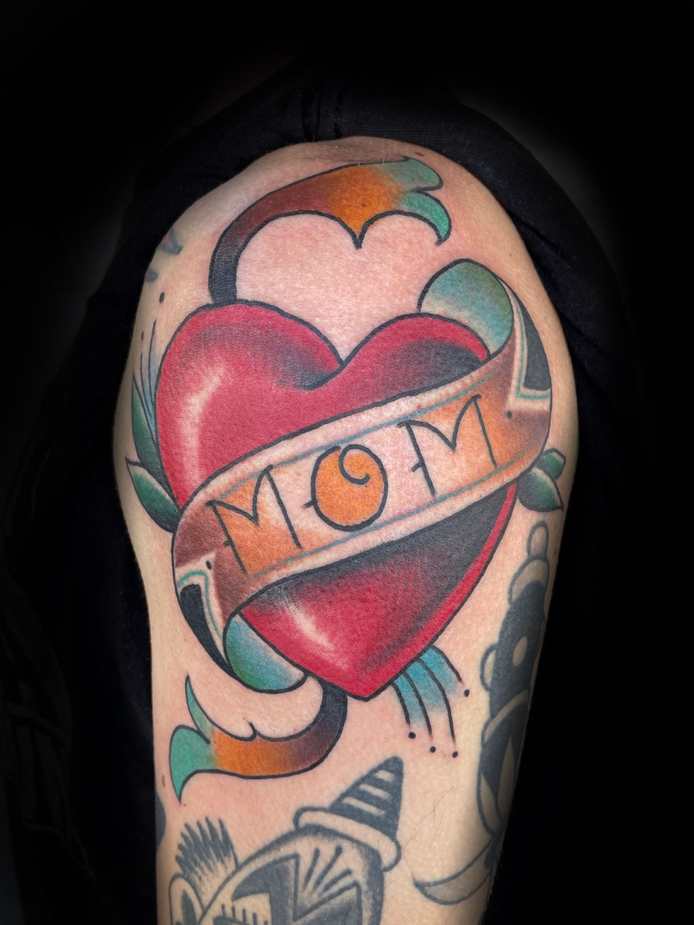 a tattoo of a heart with the word mom on it