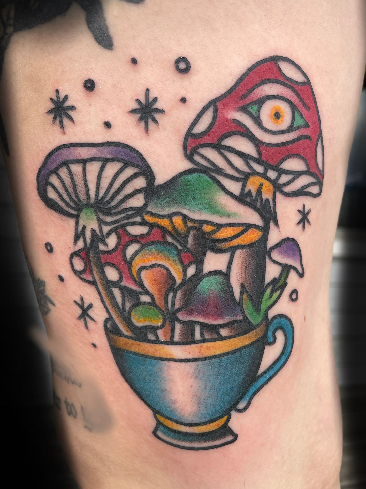 a person has a tattoo of mushrooms in a cup