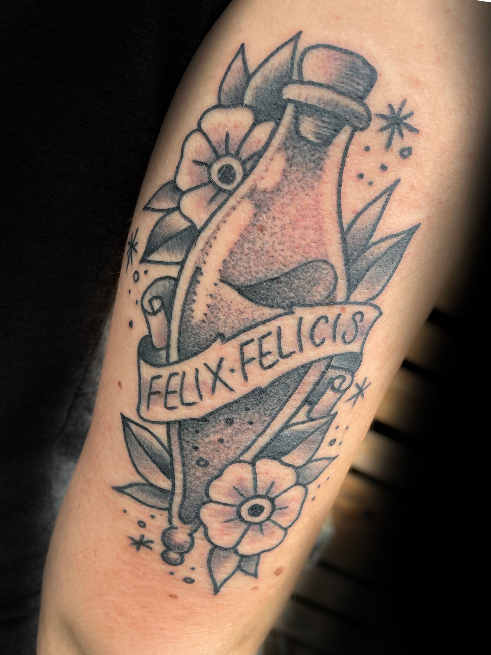 a tattoo of a bottle with a banner that says felix felicis