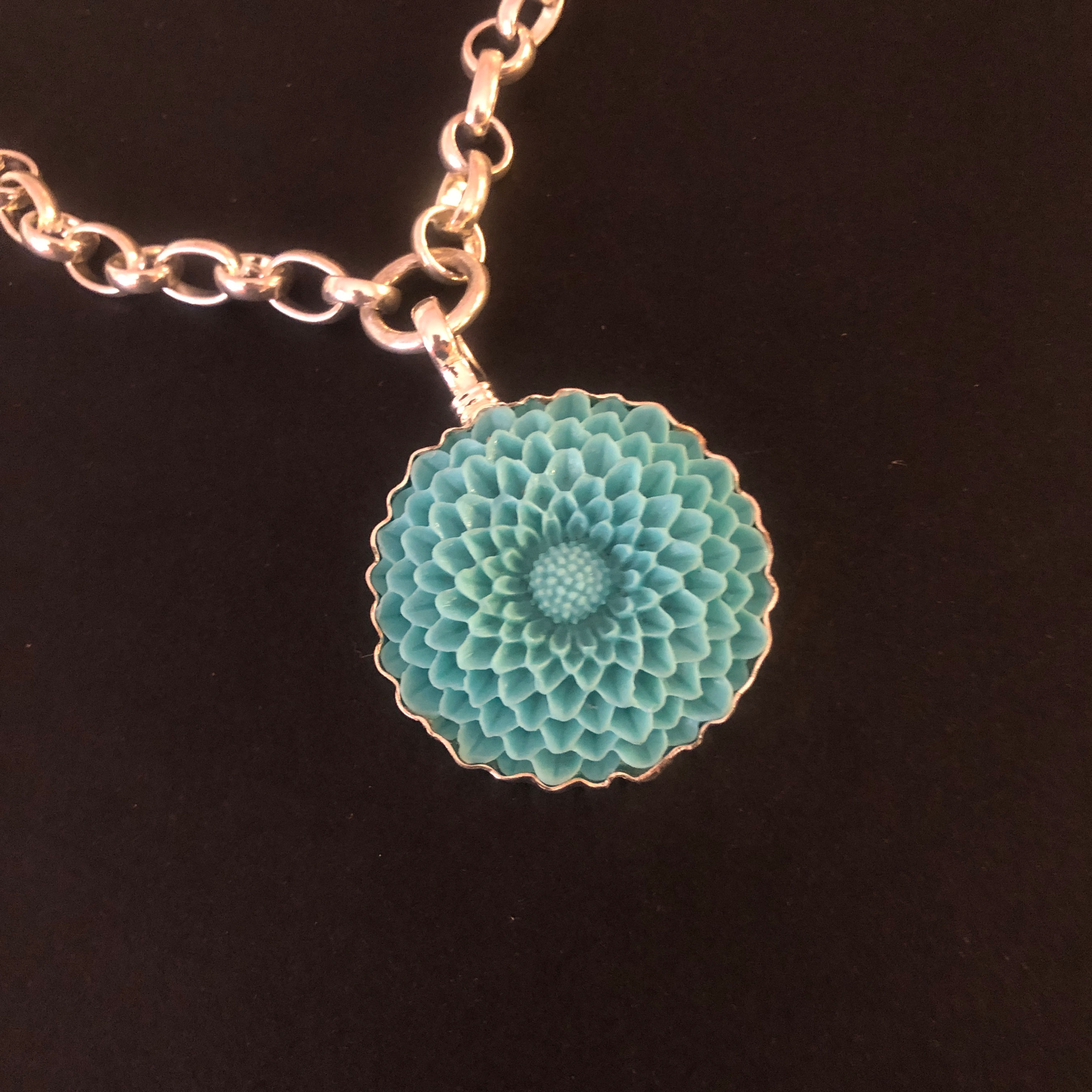 a 1.5 inch blue resin charm of a dahlia flower by Coreen Cordova Jewelry