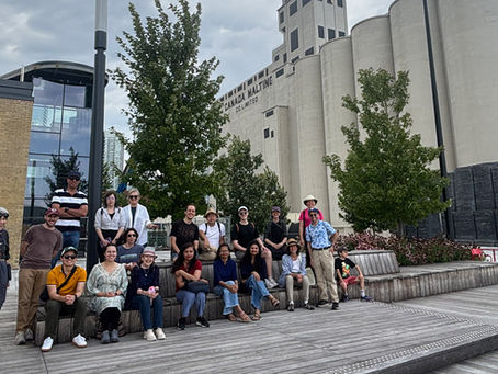 The Strong Towns Toronto walking tour in front of the Corleck Centre with the Malting Silos and the CN Tower in the background.