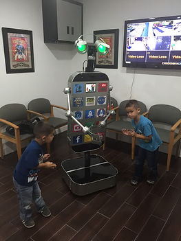 Fonebot's surrounded by young fans in an office