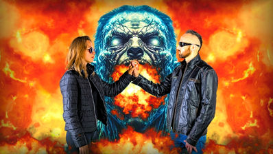 ROMAN CIGI and model Vlada Mashchenko studio portrait  with crossed fingers set against a fiery zombie head  background — official artwork for "I'm Alive"  (Brosso Remix), the million-stream London techno  release featured on Soundevote
