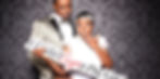 Black Couple holding I didn't sign a prenup photo booth sign