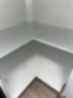 Stained white corner cabinet shelf showing our results.