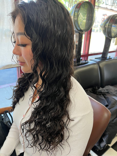 Long straight hair transformed with a lovely spiral perm