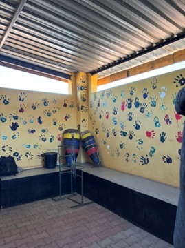 Two drums on the benches inside the youth corner in Chidi