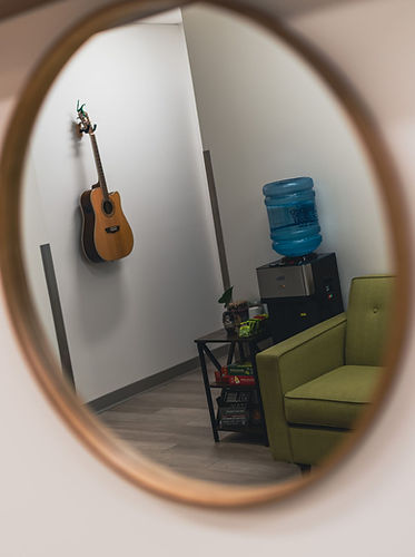 reflection mirror image with guitar and green couch