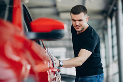 young-man-polishing-his-car-with-rag.jpg