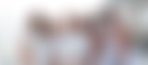 Group of Black friends dressed in white enjoying Dubai views from a private yacht"