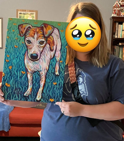 Woman holding a custom pet portrait commission work.