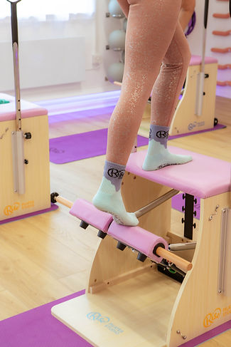 Close-up of a client pressing the spring-loaded pedal of a Wunda Chair with control