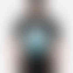 Person wearing a black shirt with a round picture of Niagara Falls and the word Niagara Falls