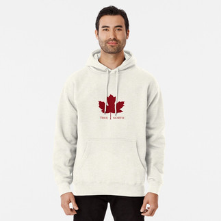 Male wearing cream hoodie with a red maple leaf with and the words True North outside the maple leaf