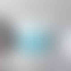 Throw pillow with a round circle in blue and a white sailboat with Lake Ontario in white letters