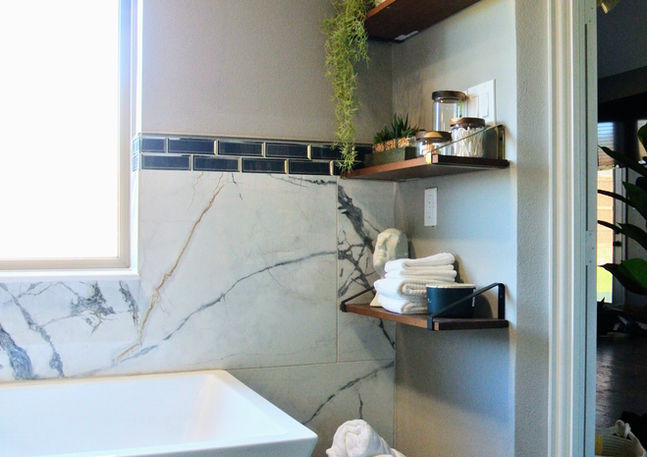 Styled shelves near bathtub
