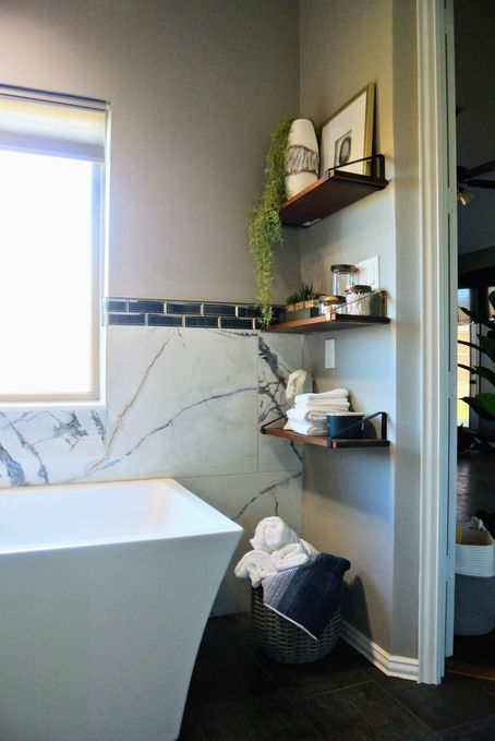 Styled shelves near bathtub