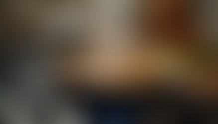 A bubbling pot of charcoal chicken gravy simmering on the stove