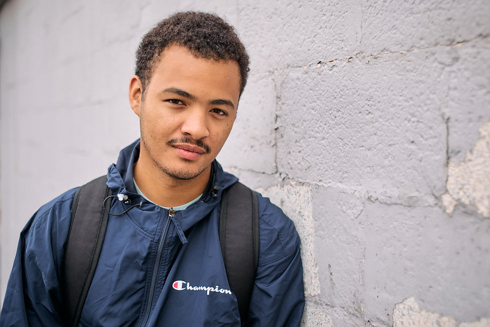 A serious headshot of a young male looking at the camera.