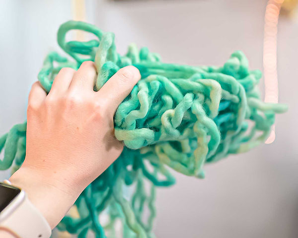 Hand-dyed wool yarn in vibrant turquoise, colored with acid dye from Dharma Trading Company during a home dyeing project.