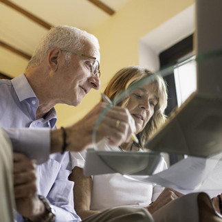 Couple reviewing living trust and estate planning documents in Boca Rato
