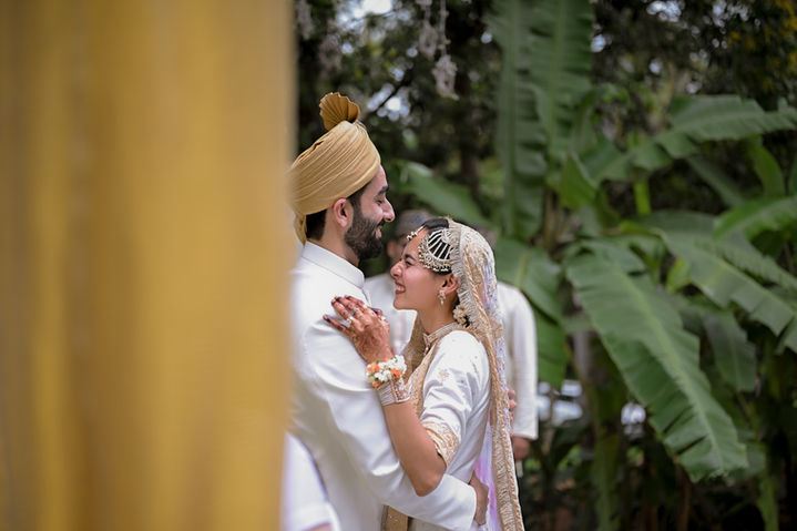 Couple posing near floral mandap in Bangalore garden