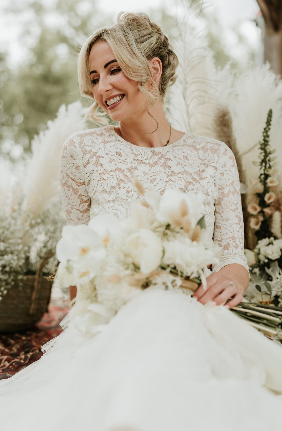 Bride in white with willow bouquet of flowers after having their makeup down by Zoe Fidgeo