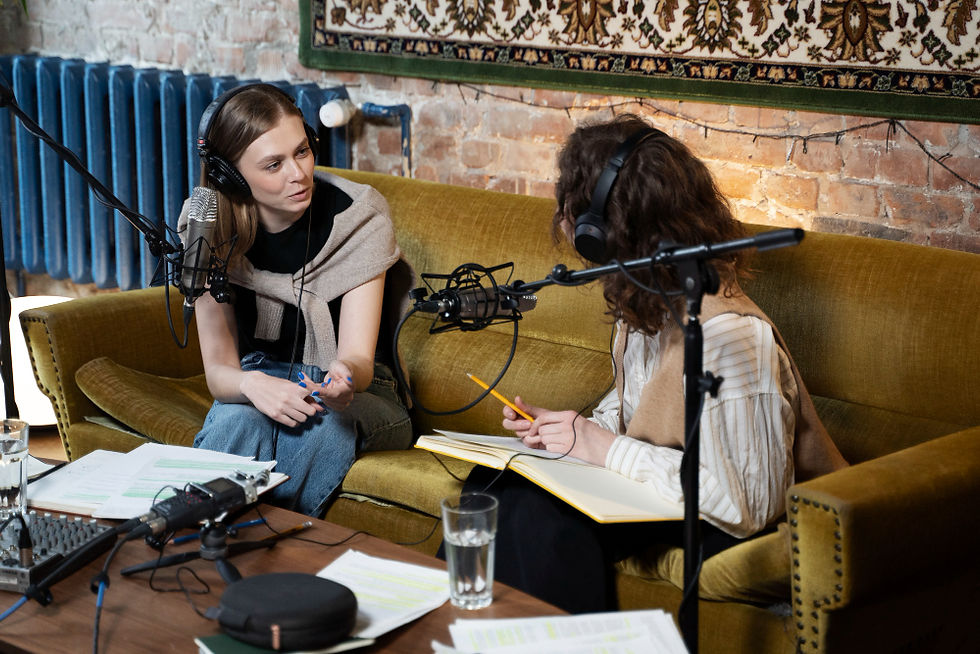 Multimedia student running a podcast with microphones and interviewee