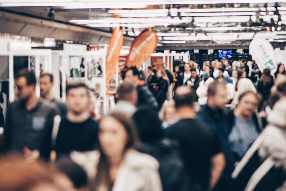 An image of an exhibition busy with people attending.