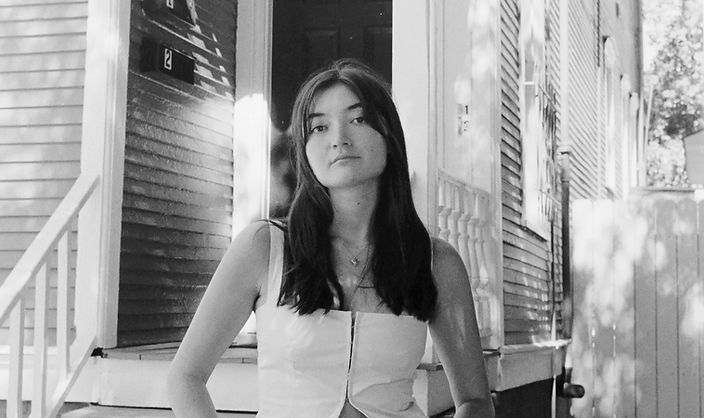 Milla Sebbah photographed outside on a sunny day in black and white film. Image taken by Sierra R. Aguilar